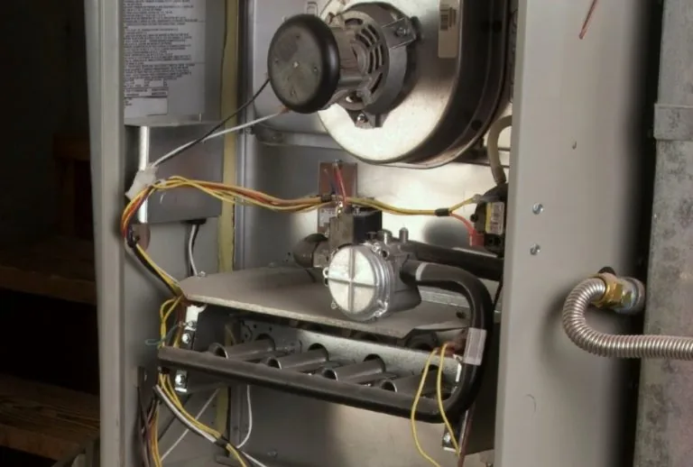 Furnace inducer motor inside a residential heating system, showing essential components for efficient operation. Paradis