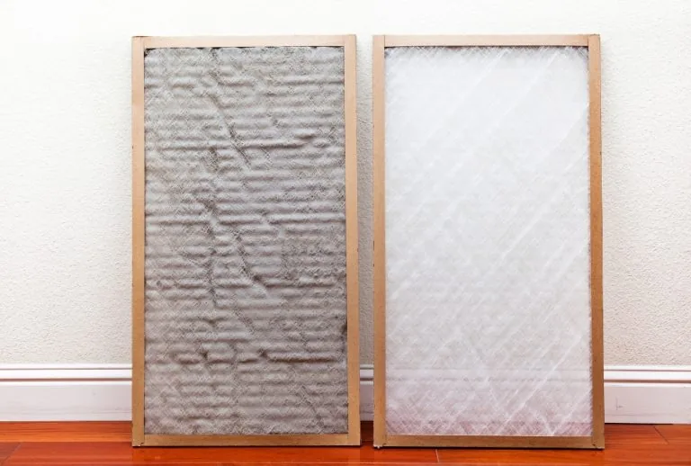 Dirty and clean air filters side by side, showing buildup that can cause musty AC smells, mildew odors, and poor indoor 