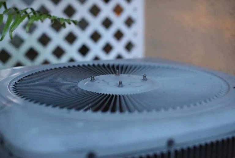 Close-up of a frozen air conditioner unit with visible ice buildup, highlighting common AC freezing issues such as restr