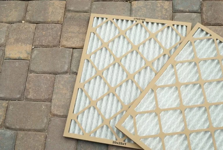 An air conditioner filter to show potential mold buildup, highlighting signs of mold in HVAC systems, indoor air quality