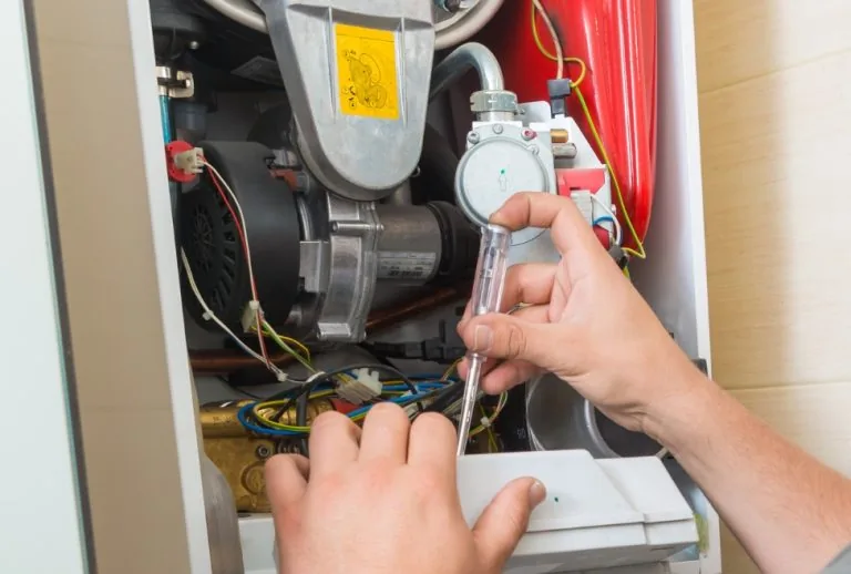 A home furnace undergoing professional inspection and maintenance by Paradise Heating and Air, helping homeowners decide