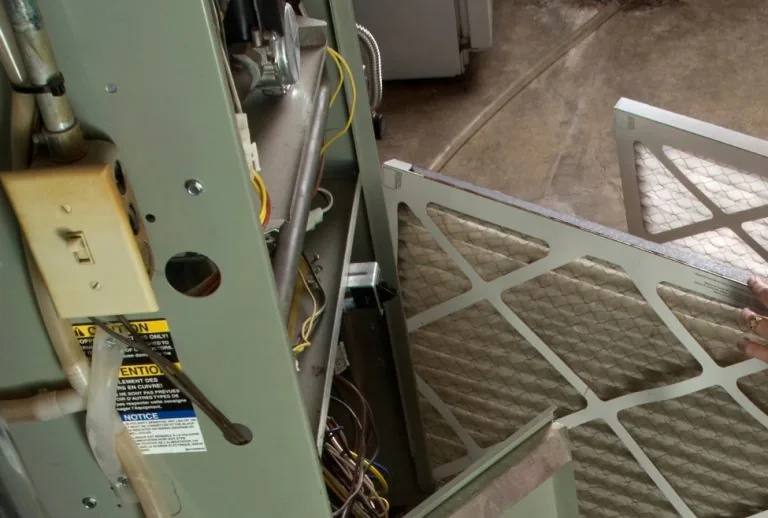 A high-efficiency furnace in a home, highlighting key components for repair, illustrating what is the most expensive par