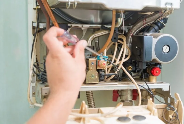 Residential furnace with internal components visible, highlighting common signs of a bad furnace pressure switch, airflo