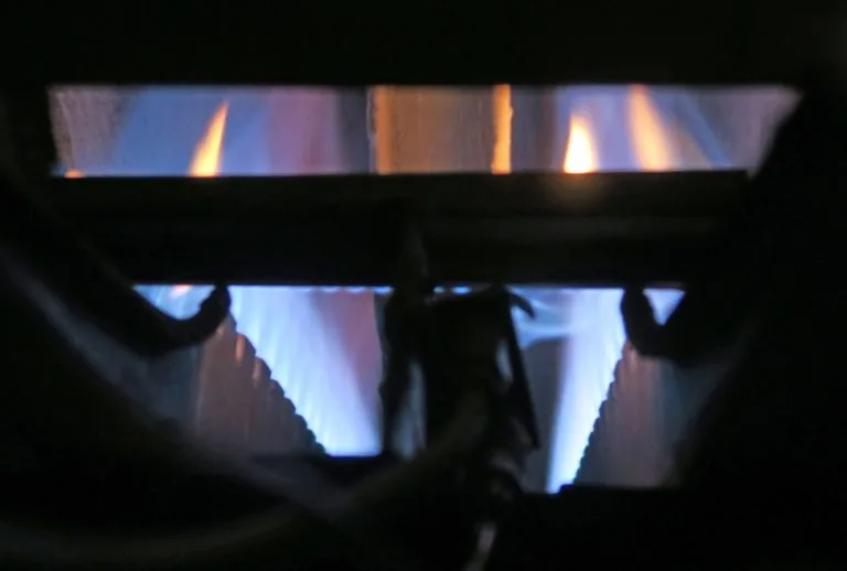 A modern furnace showing the pilot light area, illustrating how to relight a furnace pilot light, troubleshoot pilot lig