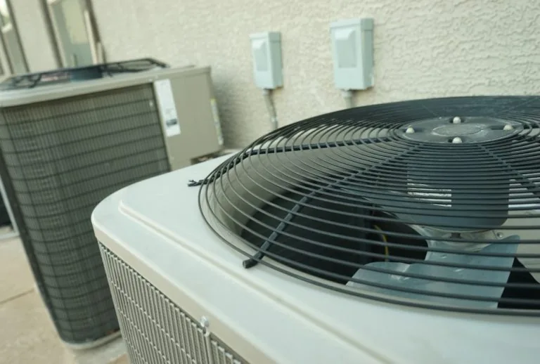 Outdoor air conditioning unit highlighting the AC compressor, showing common issues like compressor failure, warm air fr