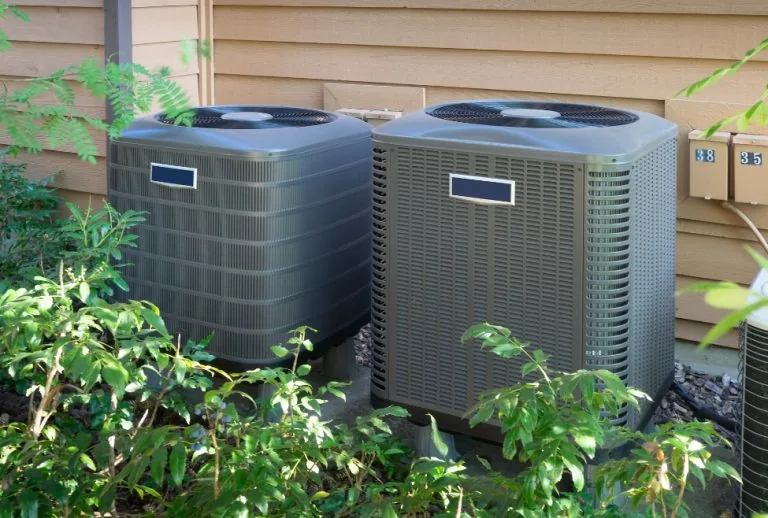 Air conditioner outdoor unit illustrating AC contactor failure symptoms including system not turning on, buzzing or clic