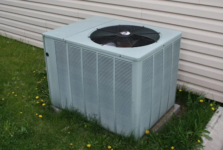 Air conditioner outdoor condenser unit showing signs of AC condenser damage, including poor cooling, overheating, refrig