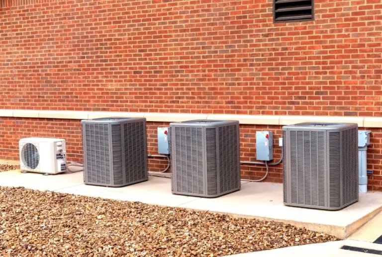 Air conditioner showing signs of water leakage, including clogged condensate drain, frozen evaporator coil, and AC dripp